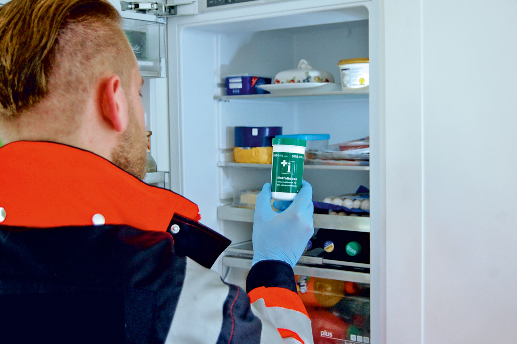 Sanitäter holt die SOS-Notfalldose aus dem Kühlschrank